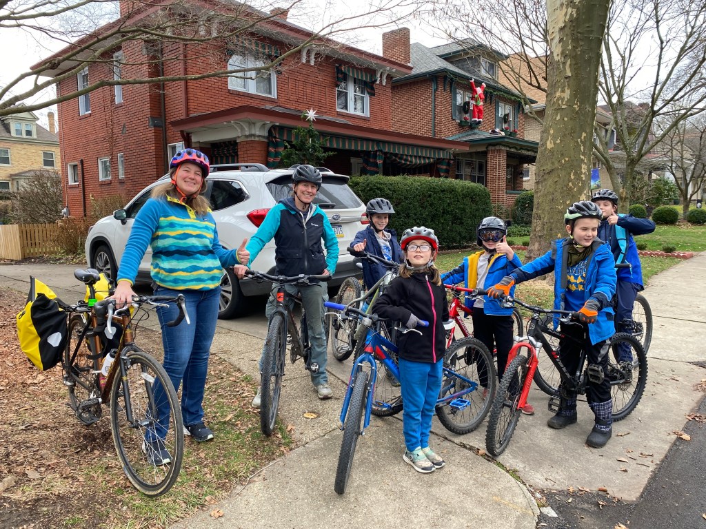A group of bikers with helmets smile before their ride.